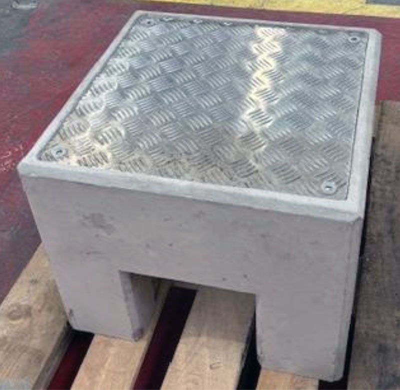 Precast charging point base fitted with a chequer plate access cover
