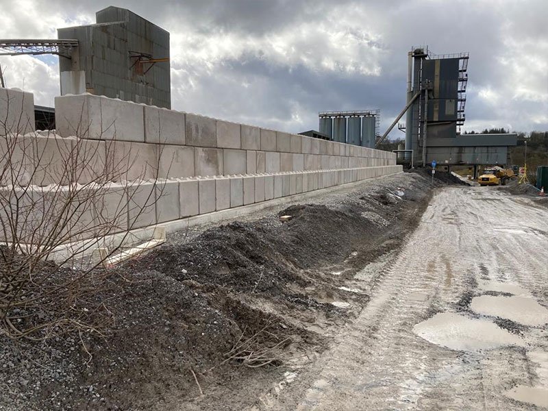 Long Legato interlocking block wall running alongside a quarry batching plant