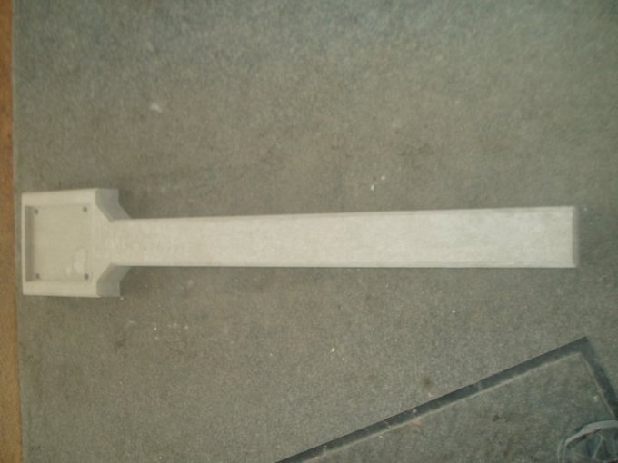 Precast concrete indicator post with splayed foot lying on a concrete floor