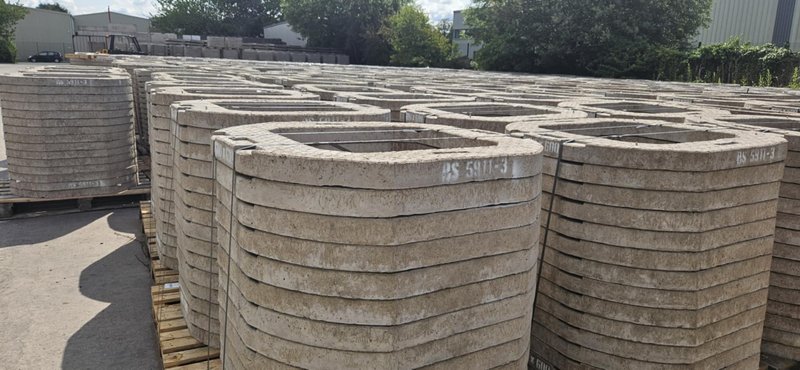 Stacks of 600x600 seating rings and cover slabs in a storage yard