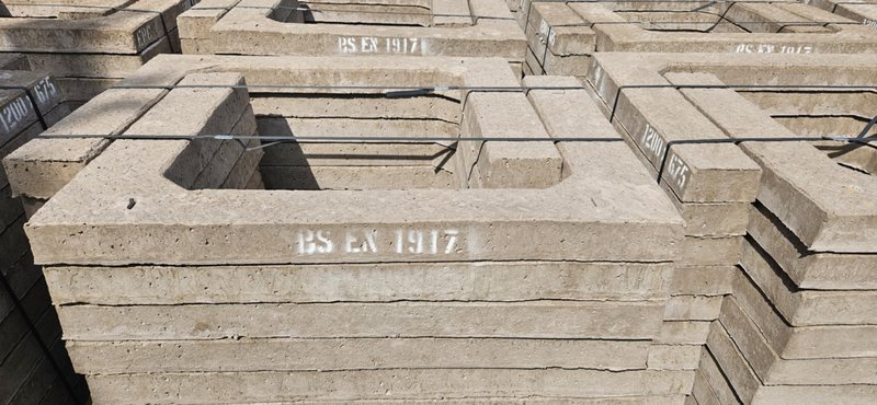 Stacked rectangular manhole adjusting units marked BS EX 1917