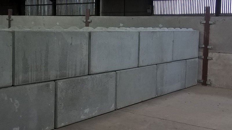 Duo interlocking blocks stacked into a dividing wall inside a grain store