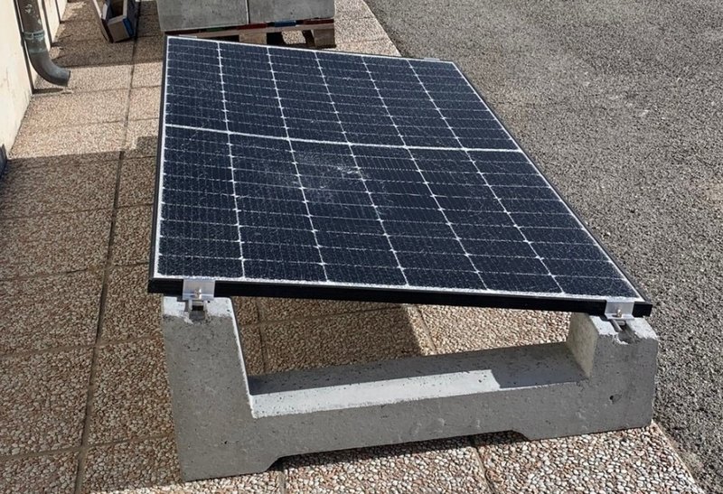 Single solar panel mounted on a precast concrete ballast frame