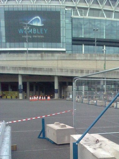 Kentledge ballast blocks weighting temporary fencing outside Wembley Stadium