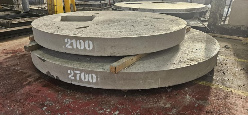Large 2100 and 2700 circular cover slabs stacked on the factory floor