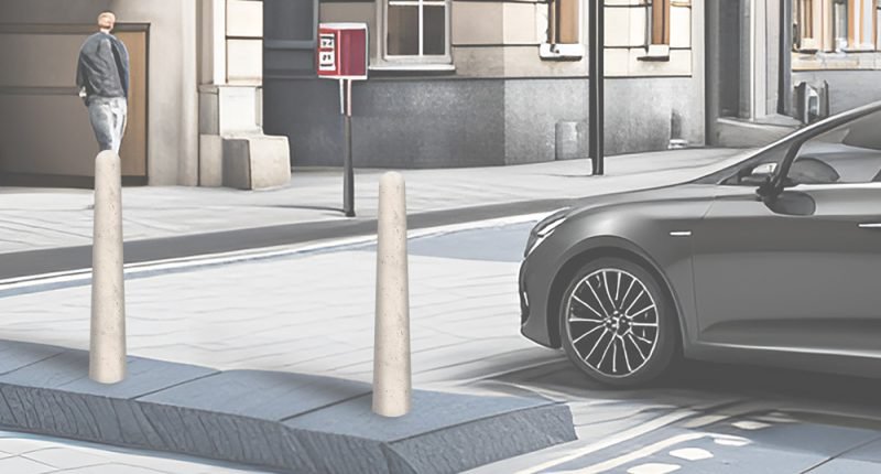 Two concrete bollards protecting a pavement beside a parked car