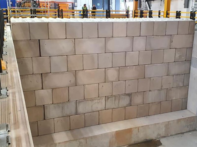 Tall Legato interlocking block wall forming a high-sided bunker inside a facility
