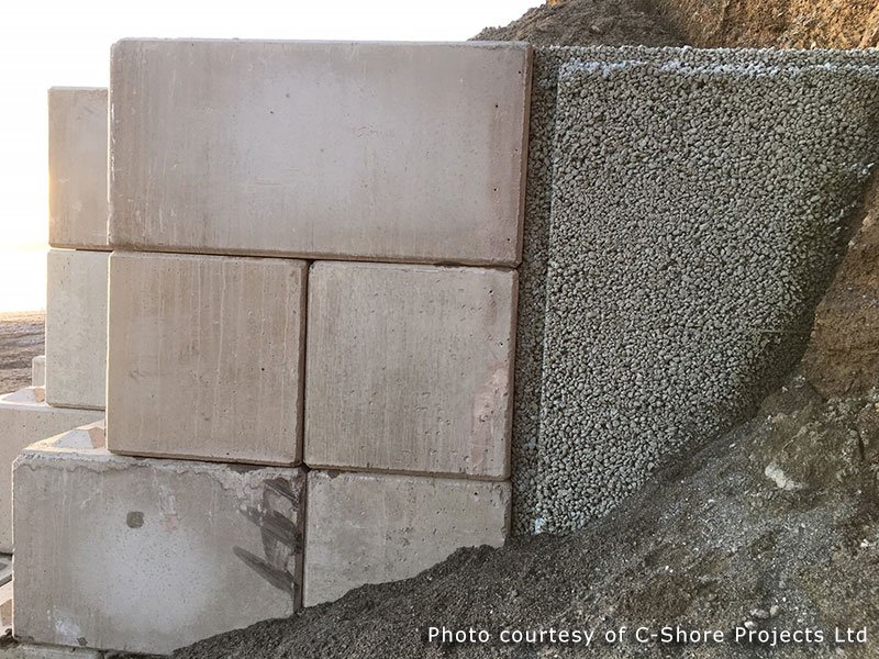Legato blocks stacked tight against a cut rock face to hold the slope