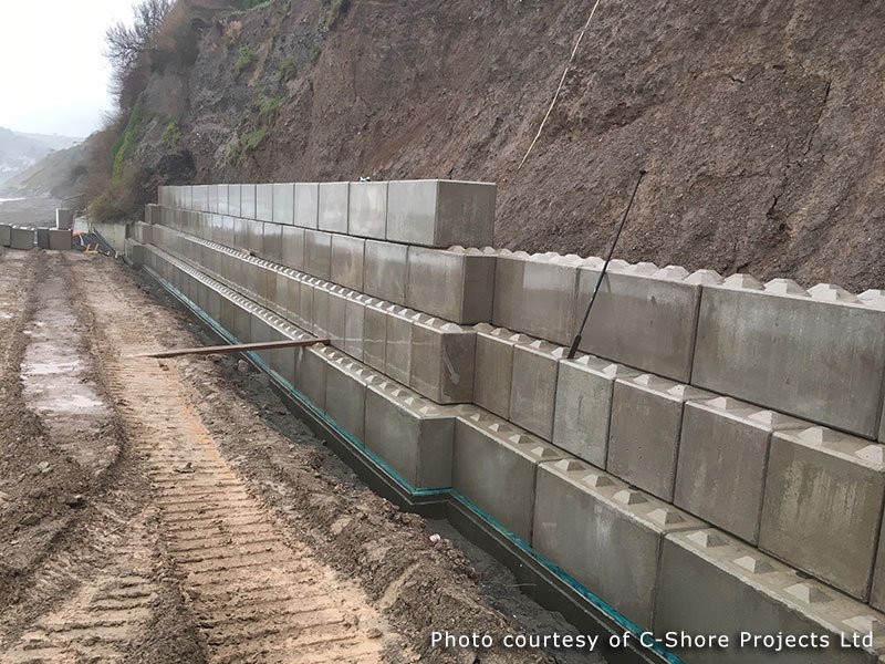 Completed Legato block sea wall running along the base of a cliff