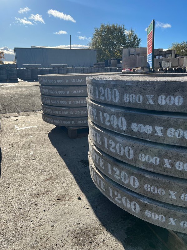 Stacked 1200 cover slabs marked 600 x 600 in a storage yard