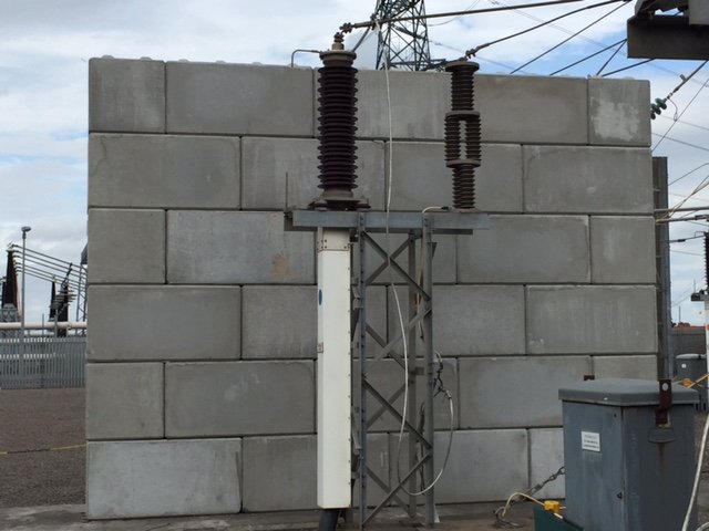 Interlocking block blast protection wall behind substation electrical equipment