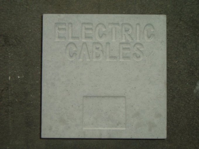 Square concrete marker block cast with Electric Cables lettering
