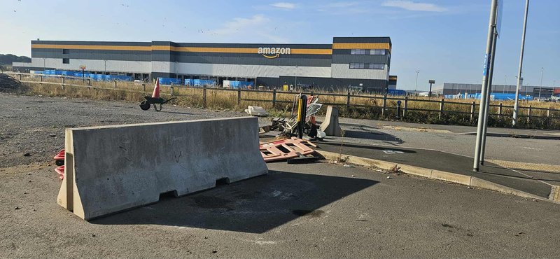 Jersey barrier on hardstanding in front of a distribution warehouse