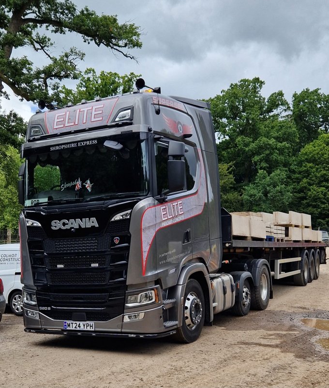 Articulated delivery lorry loaded with precast units on its flatbed trailer