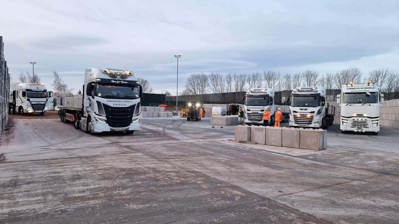 Lorries loading concrete blocks in the yard at a precast works