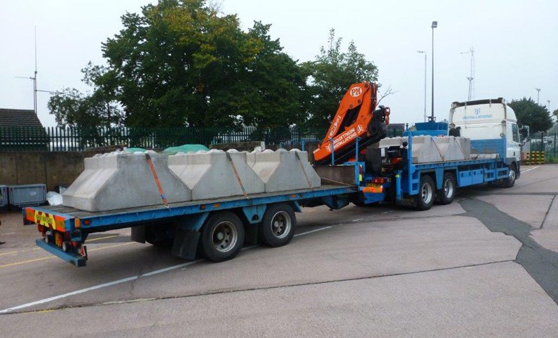 Wagon and drag lorry with crane loaded with V-shaped kentledge ballast blocks