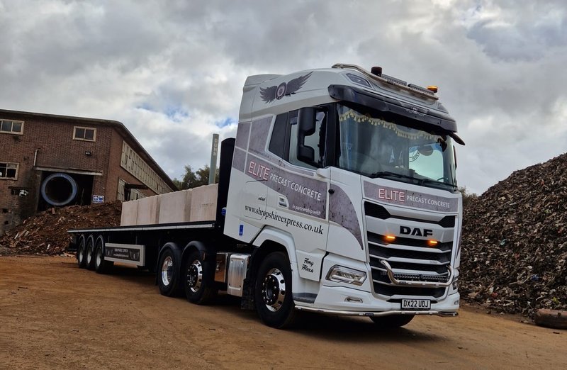 Flatbed delivery lorry parked on a yard ready to load precast units