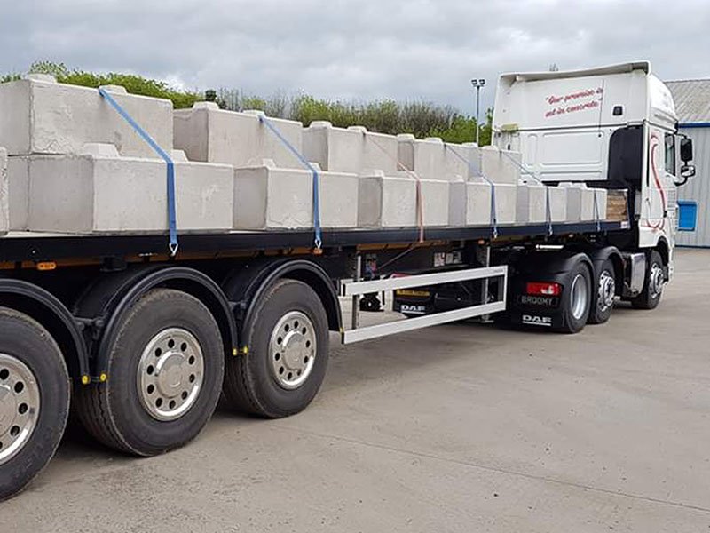 Flatbed trailer loaded and strapped with a row of Duo blocks for delivery