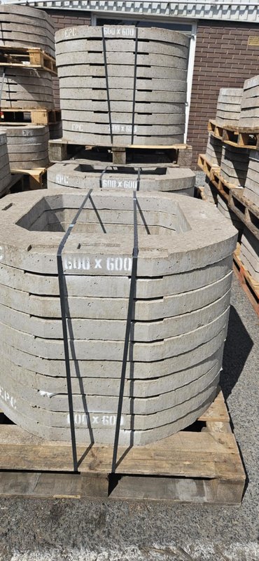 Banded stack of 600x600 concrete polo adjusting units on a pallet