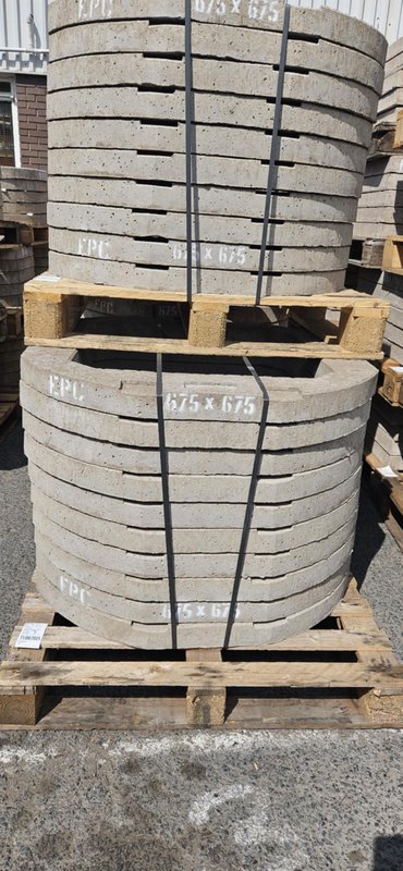 Banded stacks of 675x675 concrete seating rings on timber pallets