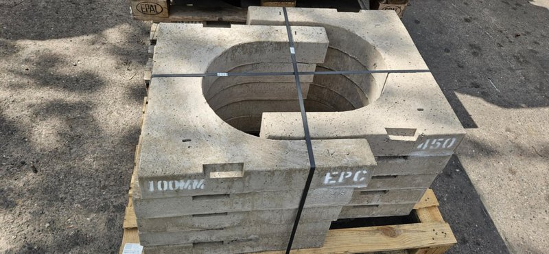 Horseshoe gully cover slabs stacked on a timber pallet outdoors