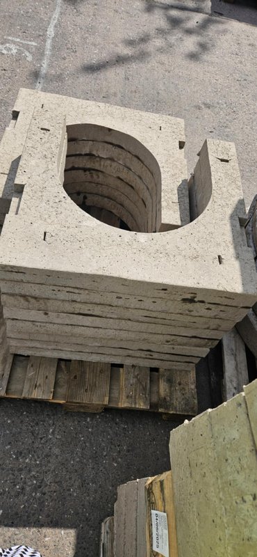 Close-up of a horseshoe-shaped gully cover slab on a pallet
