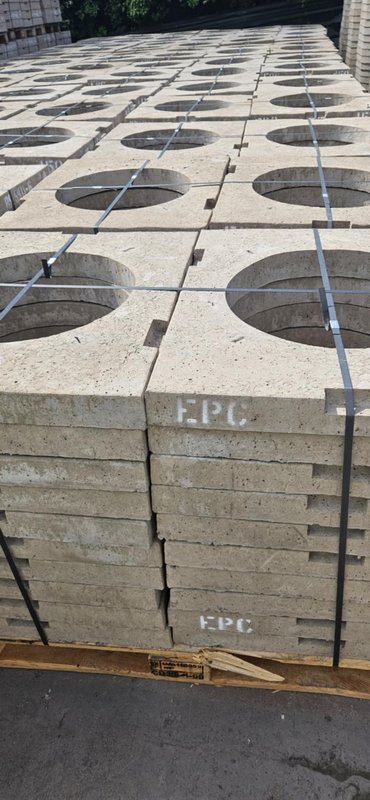 Stacked pallets of square gully cover slabs with circular openings