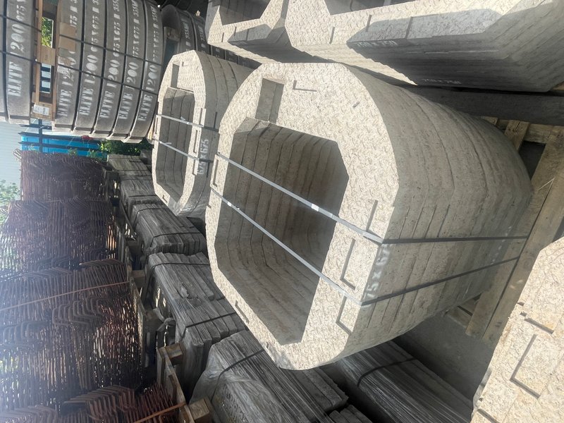 Stacked precast manhole adjusting units strapped in bundles at the works