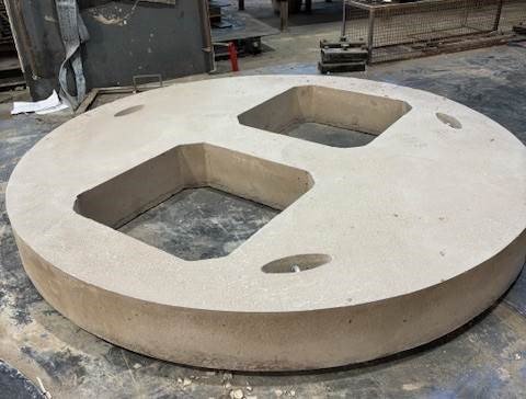 Circular concrete cover slab with two rectangular and one round access opening