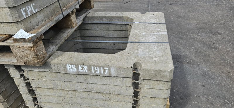 Close-up of a square seating ring stamped BS EN 1917 on a stack