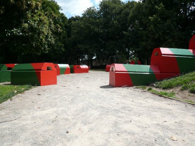 Duo blocks painted red and green forming play features in a park