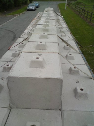 Duo interlocking blocks laid end to end down a tarmac driveway