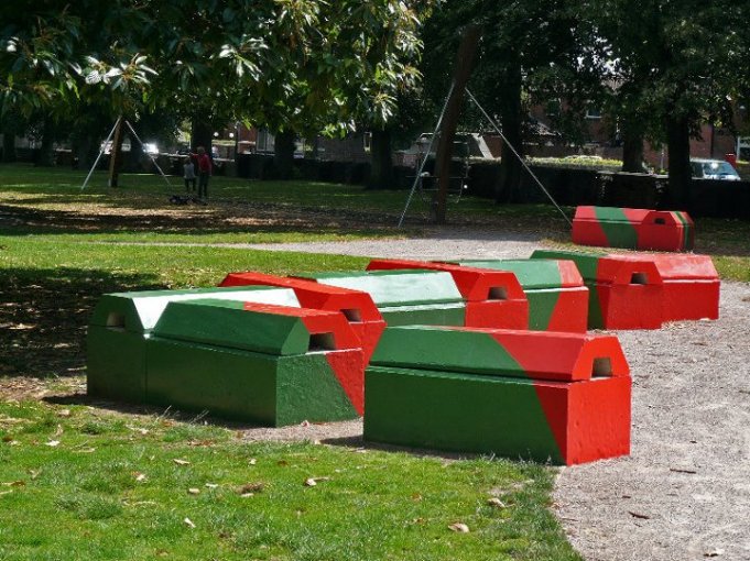 Duo blocks painted red and green forming play features in a park