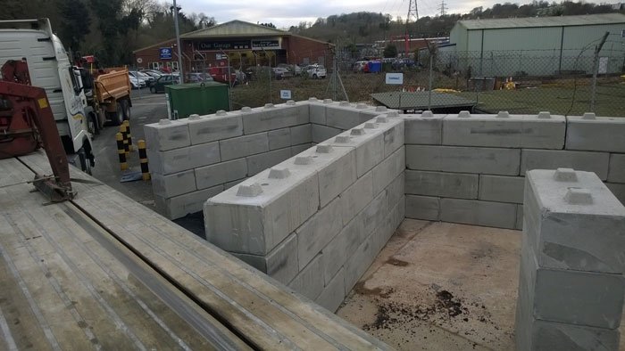 Duo blocks built up into storage bay walls on a working site