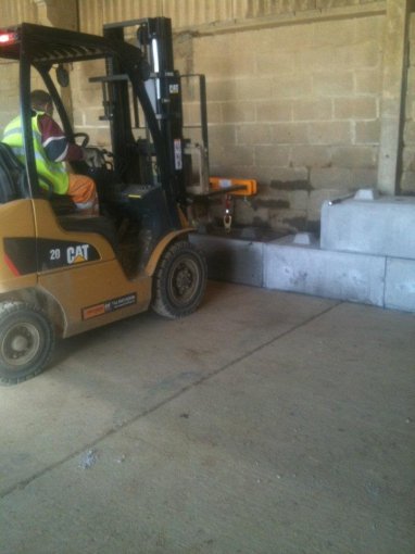 Forklift positioning a Duo block against an internal wall inside a building