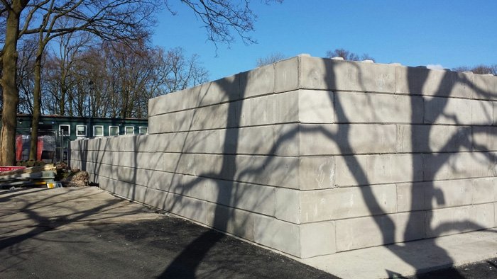 External corner of a Duo block storage bay wall in a sunlit yard