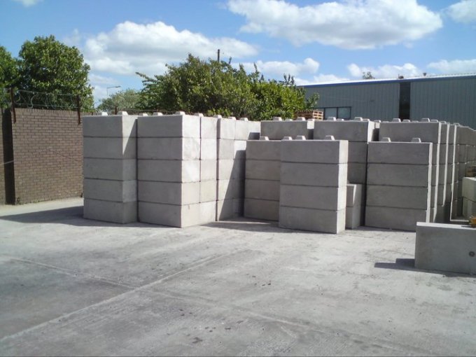 Duo interlocking blocks stacked in rows across a concrete storage yard