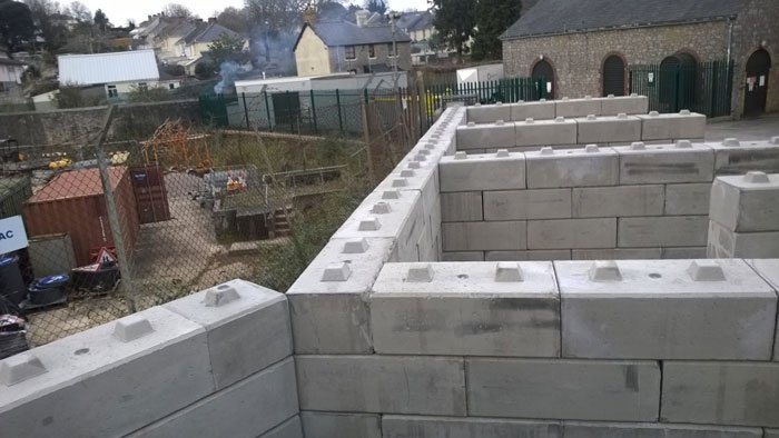 Duo interlocking blocks built into storage bay walls behind housing