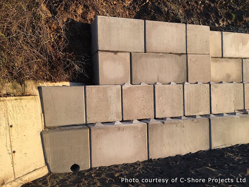 Stacked Legato blocks retaining an earth bank behind a sea wall
