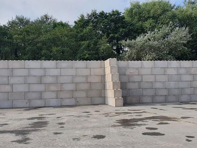 Legato interlocking blocks stacked into a freestanding fire break wall in a yard
