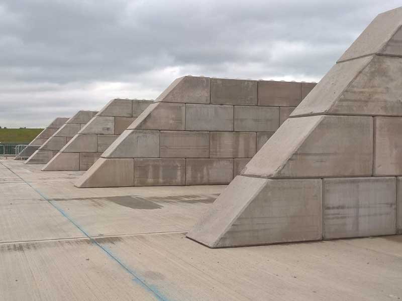 Legato block walls with stepped tapered ends dividing open storage bays