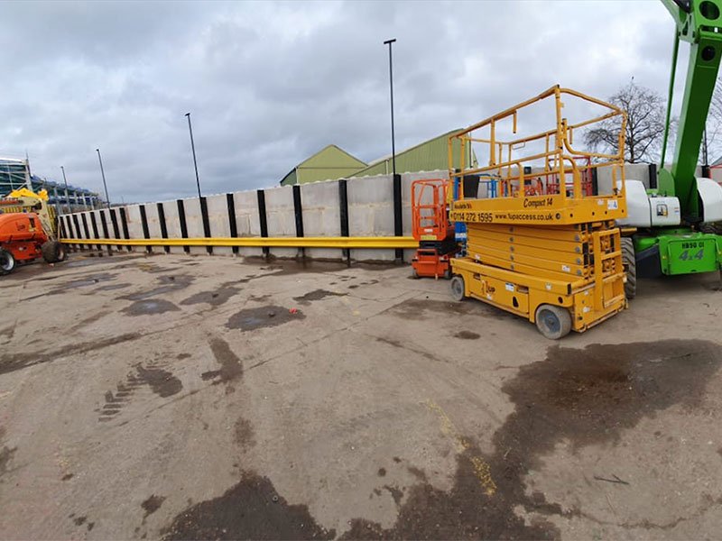 Precast concrete flood defence wall under construction with access platforms alongside