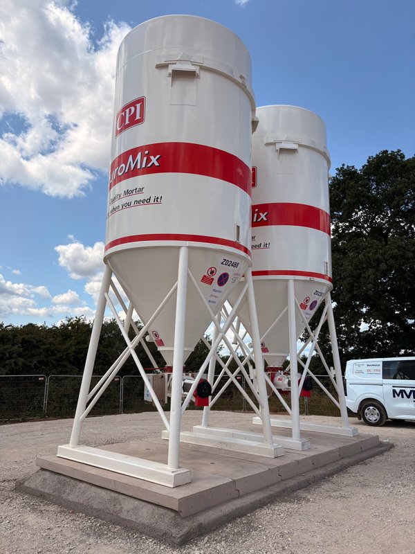 Two EuroMix cement silos standing on precast foundation base slabs