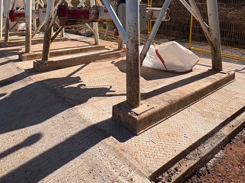 Silo legs bearing onto precast concrete foundation base slabs on a prepared pad