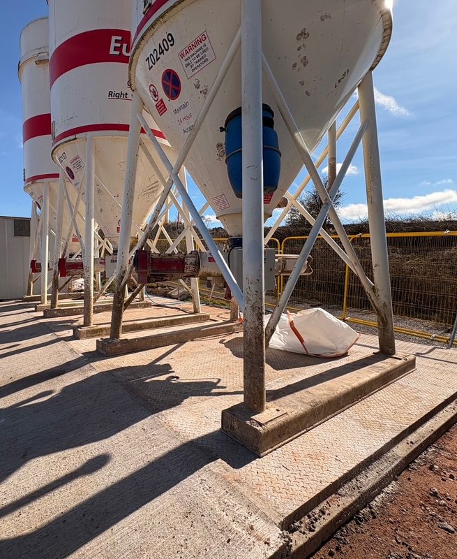 Silo support legs bolted down onto precast concrete foundation base slabs