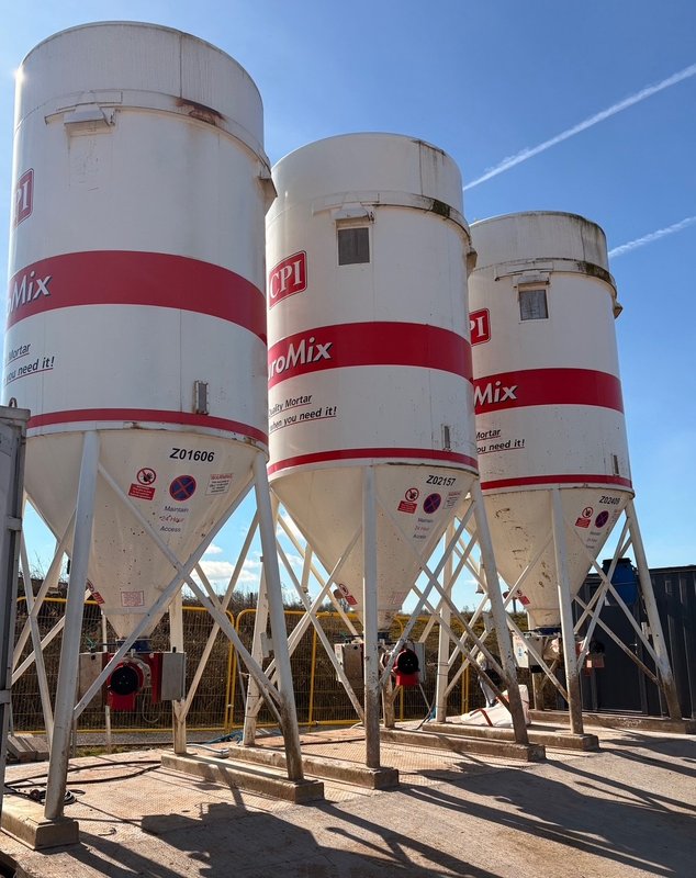 Row of EuroMix cement silos supported on precast foundation base slabs