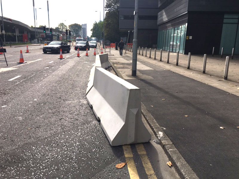 Jersey barriers set out on a city street to separate traffic from pedestrians