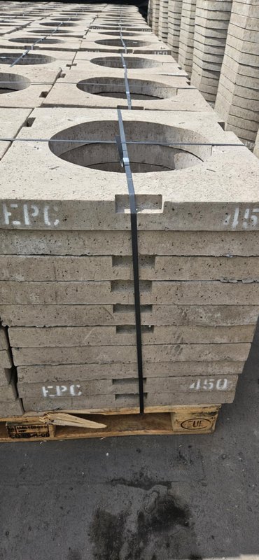 Pallet of precast concrete gully cover slabs with round openings