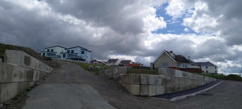 Low Legato block wall retaining ground beside a new access road at a holiday park