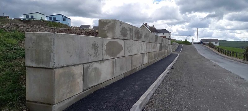 Interlocking block protective walling running alongside a hillside access road